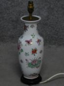 A vintage hand painted porcelain Chinese vase lamp base on carved hard wood stand. With floral and