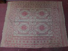 An Engsi style symmetrical rug on an ivory and rouge field surrounded by multiple geometric