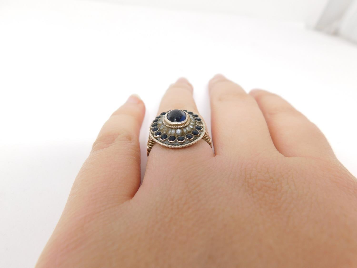 An antique Austrian silver, blue stone and seed pearl cluster ring. Set to centre with an oval - Image 7 of 15