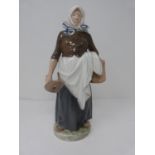 A Royal Copenhagen milk maid hand painted porcelain figure. She is holding a wooden pail and a
