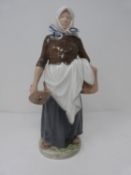 A Royal Copenhagen milk maid hand painted porcelain figure. She is holding a wooden pail and a