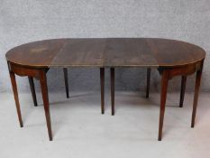 A Georgian mahogany extending dining table with satinwood strung inlay on square tapering