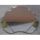 An Art Deco cloud shaped triple section mirror with bevelled glass and green bakelite detailing.