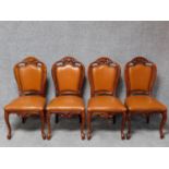 A set of four Italian walnut dining chairs in tan leather upholstery on cabriole supports. H.100cm