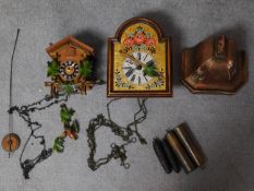 Two vintage Continental wall clocks and a painted plaster plinth base. One clock is a carved