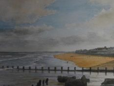 A framed and glazed watercolour depicting a beach scenery, signed Ken Perry. 43x35cm