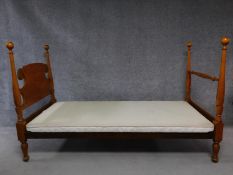 A walnut framed single bed. H.128 W.210 D.100cm
