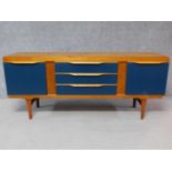 A vintage Elliotts of Newbury sideboard with three central drawers flanked by two panel doors. H.