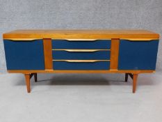 A vintage Elliotts of Newbury sideboard with three central drawers flanked by two panel doors. H.