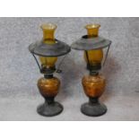A pair of vintage amber moulded glass and metal oil lamps. Stamped made in Hong Kong to base. H.43cm
