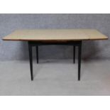 A 1960's vintage draw leaf dining table with Formica top on ebonised supports. H.71 W.150 D.75cm