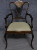 A late 19th century rosewood armchair with ivory and satinwood inlay raised on cabriole supports.