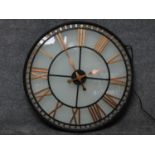 A glass fronted shop display clock with gilded roman numerals, wired and internally lit. 80x80cm