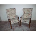 A PAIR OF UPHOLSTERED WING BACK ARMCHAIRS