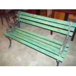 A GREEN WOODEN BENCH