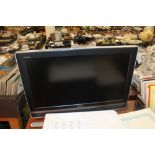 A SONY 32" FLATSCREEN TV WITH REMOTE