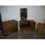 A TEAK 1950S DRESSING TABLE, FOUR DRAWER CHEST OF DRAWERS AND A BEDSIDE CABINET (3)