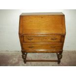 AN OAK TWO DRAWER BUREAU