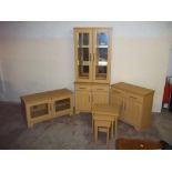 A MODERN LIGHT OAK CABINET, TV UNIT, NEST OF TABLES AND A TALL DISPLAY CABINET