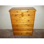 A HONEY PINE TWO OVER FOUR CHEST OF DRAWERS