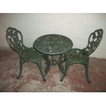 A CAST GARDEN TABLE + TWO CHAIRS