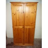 A HONEY PINE WARDROBE