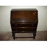 AN OAK TWO DRAWER BUREAU