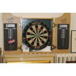 A DARTBOARD IN CABINET WITH DARTS
