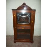 A GLASS FRONTED DISPLAY CABINET