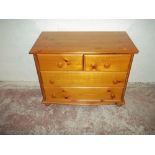 A HONEY PINE TWO OVER TWO CHEST OF DRAWERS