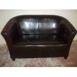 A LEATHER EFFECT TWO SEATER SOFA