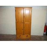 A HONEY PINE WARDROBE