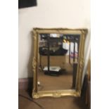 A GILT FRAMED MIRROR 80 X 58 CM