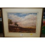 A FRAMED AND GLAZED WATERCOLOUR DEPICTING CATTLE IN A LANDSCAPE SIGNED JOHN KEELEY