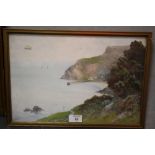 A FRAMED AND GLAZED WATERCOLOUR OF A COASTAL SCENE INDISTINCTLY SIGNED LOWER LEFT