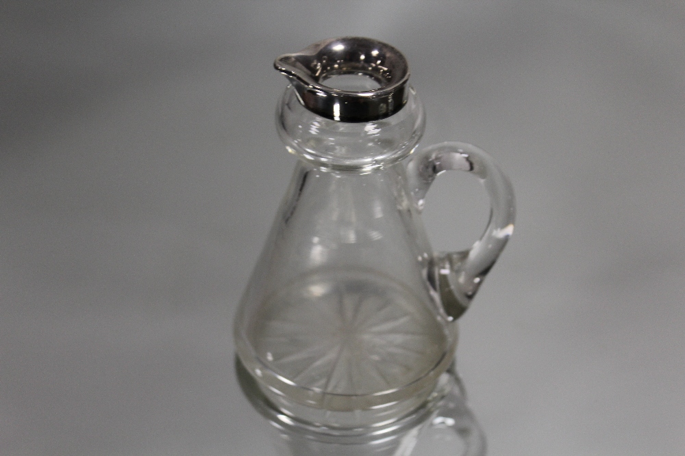 A HALLMARKED SILVER RIMMED WHISKY NOGGIN