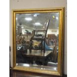 A GILT FRAMED BEVEL EDGED WALL MIRROR W- 71.5CM X H-86.5CM