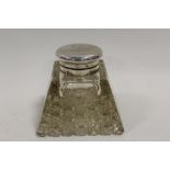A STYLISH EDWARDIAN SILVER LIDDED INKWELL - LONDON 1909, makers marks for C.B.& Sons, of