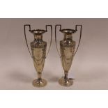 A PAIR OF HALLMARKED SILVER ART NOUVEAU TROPHY HANDLED VASES, hallmarks rubbed, H 20 cm (2)