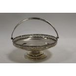 A HALLMARKED SILVER SWING HANDLED TAZZA - BIRMINGHAM 1923, reticulated band to edge of bowl, similar