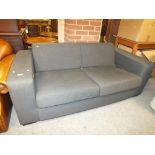 A MODERN UPHOLSTERED LARGE SETTEE