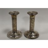 A PAIR OF HALLMARKED SILVER CANDLESTICKS - BIRMINGHAM 1905, with swags and tail decoration, engraved