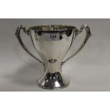 A HALLMARKED SILVER TWIN HANDLED CHALICE - SHEFFIELD 1912, makers mark for H.A., of trophy form, the