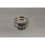 AN 18 CARAT GOLD ILLUSION SET THREE STONE RING