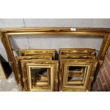 A COLLECTION OF SIX SMALL 20TH CENTURY GILT PICTURE FRAMES TOGETHER WITH A LARGE EXAMPLE (7)