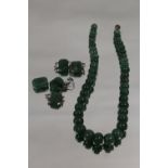 A SINGLE STRAND OF GRADUATED SPINACH JADE BEADS A/F, L 35 cm, together with five shaped panels