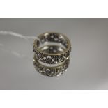 A PIERCED ETERNITY RING, set with white stones, ring size Q