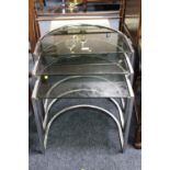 A RETRO CHROME AND GLASS NEST OF TABLES