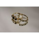 A HALLMARKED 9 CARAT GOLD THREE STONE SAPPHIRE DRESS RING TOGETHER WITH ANOTHER SET WITH GREEN AND