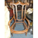 A MAHOGANY ARMCHAIR IN NEED OF RESTORATION